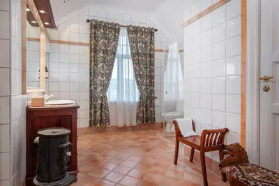 a bathroom with a toilet and a sink and a chair at Jervell 4 Bnb in Ålesund