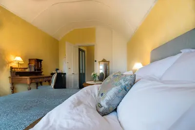 a bedroom with a bed and a piano in a room at Jervell 4 Bnb in Ålesund