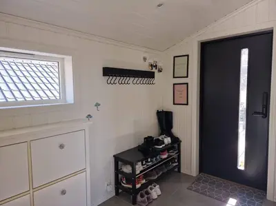 a room with a door and a shelf with shoes at Ski VM 2025 Hus 20 min til Granåsen og trdh in Melhus