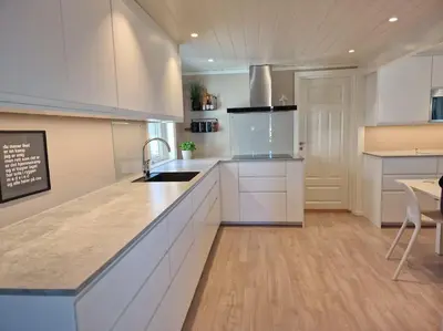 a kitchen with white cabinets and a counter top at Ski VM 2025 Hus 20 min til Granåsen og trdh in Melhus