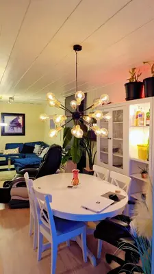 a dining room with a white table and chairs at Room In Handsome Haven House in Gjøvik