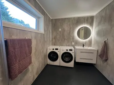 a laundry room with a washing machine and a sink at Leilighet på Hardbakke in Lia
