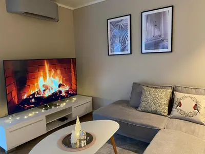 a living room with a couch and a fireplace at Leilighet på Hardbakke in Lia