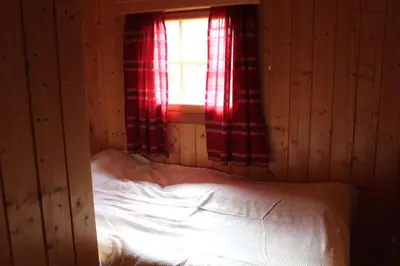 a small bedroom with a bed with a window at Granbu by Norgesbooking - cozy cabin at Golsfjellet in Ulnes