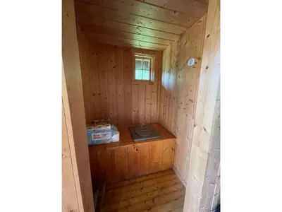an inside view of a wooden cabin with a stove in it at Granbu by Norgesbooking - cozy cabin at Golsfjellet in Ulnes