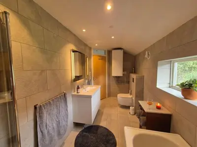 a large bathroom with a sink and a toilet at Cozy Home with Sauna, river views and 10 min from Hafjell and Lillehammer in Fåberg