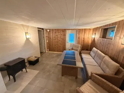 a living room with a couch and a table at Fantastisk feriehus på Tretten, Hafjell in Tretten