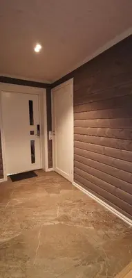 an empty room with two doors and a stone floor at Fantastisk feriehus på Tretten, Hafjell in Tretten