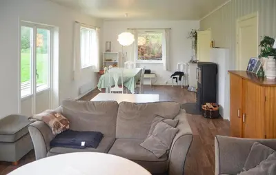 a living room with a couch and a table at Lovely Home In Sørbøvåg in Sørbø