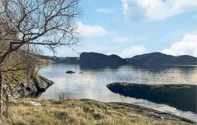 a large body of water with mountains in the background at Lovely Home In Sørbøvåg in Sørbø