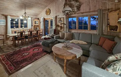 a living room with a couch and a table at Gorgeous Home In Tuddal in Tuddal