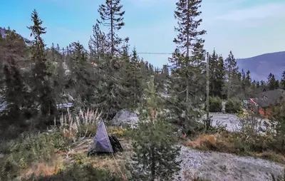 a tent sitting on top of a hill next to trees at Gorgeous Home In Tuddal in Tuddal