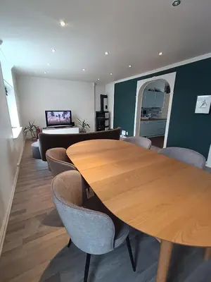 a dining room with a wooden table and chairs at Flott leilighet med herlig utsikt in Ålesund
