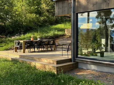 a patio with a table and chairs outside of a house at Tyristua in Gjesval