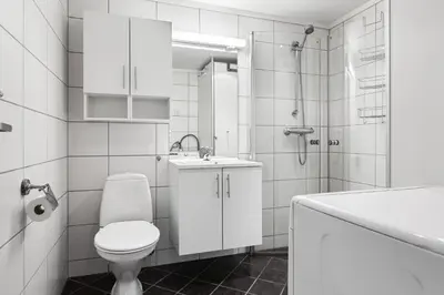 a white bathroom with a toilet and a sink at Naturopplevelser året rundt i Valdres Ski in out Panoramautsikt in Aurdal