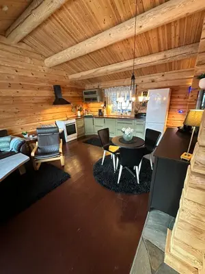a kitchen and living room with a table and chairs at Hytte Oppdal Så Klart in Oppdal