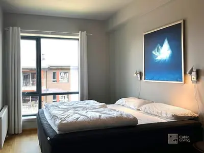 a bed in a bedroom with a large window at Modern Apartment in Trysil Lodge Ski in out in Trysil