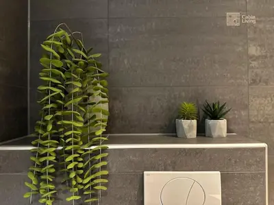 a plant sitting on a counter next to two potted plants at Modern Apartment in Trysil Lodge Ski in out in Trysil