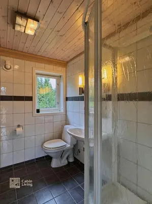 a bathroom with a toilet and a sink at Cabin at Sjusjøen Birkebeiner trail ski in out, 8 beds, 2 bathrooms & Wifi in Sjusjøen