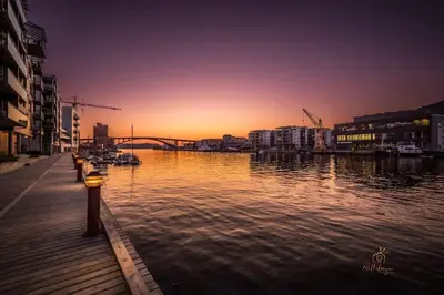 a body of water with a pier and a bridge at Dining Apartments l Restaurants with sea I City Traveller & Workspace in Bergen