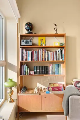 a book shelf filled with books in a room at Dining Apartments l Restaurants with sea I City Traveller & Workspace in Bergen