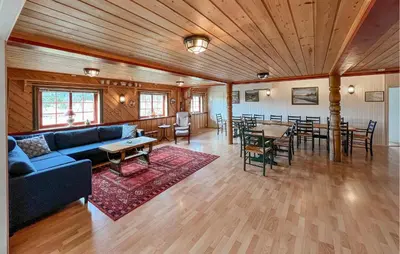 a living room with a blue couch and tables and chairs at 4 Bedroom Gorgeous Home In Bagn in Bagn