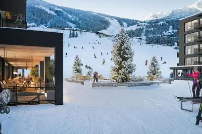 a group of people skiing down a snow covered slope at Ski-in ski-out - Hemsedal in Fjellandsbyen - view to the slopes in Hemsedal
