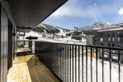 a balcony with a view of the snow covered mountains at Ski-in ski-out - Hemsedal in Fjellandsbyen - view to the slopes in Hemsedal