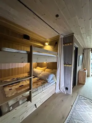a room with a bed in the middle of a room at Ski-in ski-out - Hemsedal in Fjellandsbyen - view to the slopes in Hemsedal