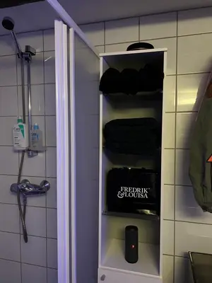 a bathroom with a towel rack with towels on it at Top Floor Apartment Trondheim in Trondheim