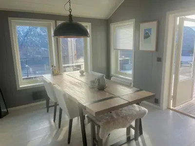 a dining room with a wooden table and chairs at Chalet with amazing fjord view in Lingåsen in Valldal