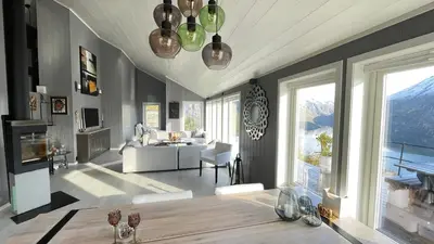 a living room with a couch and a table at Chalet with amazing fjord view in Lingåsen in Valldal