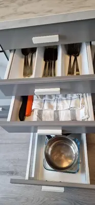 a kitchen drawer with a frying pan in it at Central 2 bedroom apartment in Lillehammer
