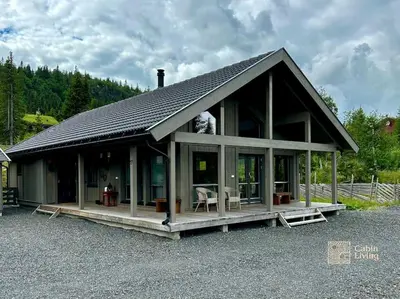 a large house with a roof on a lot at Modern cabin Skeikampen with ski-in out cross country trails & great view in Aulstad
