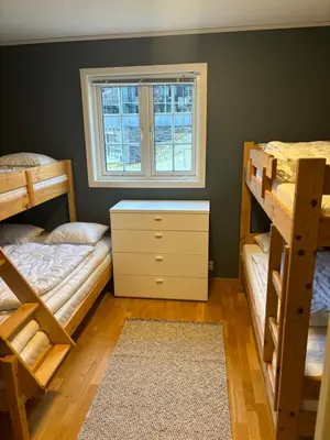 a bedroom with two bunk beds and a window at Røldal a home with a view in Håra