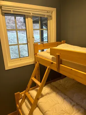 a bedroom with two bunk beds and a window at Røldal a home with a view in Håra