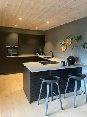 a kitchen with two bar stools and a sink at Hovden Alpin Lodge! Ski in out in Hovden