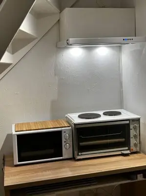 two microwaves sitting on a counter in a kitchen at Trondheim sentrum, Lade - Nyhavna, gratis parkering in Trondheim