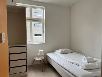 a small bedroom with a bed and a window at Bendixens vei 57 in Bergen