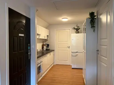 a kitchen with white cabinets and a white refrigerator at Bendixens vei 57 in Bergen