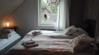 a bedroom with a bed with towels on it at Voss- Myrkdalen Lodge in Vossestrand