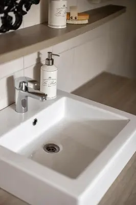 a white bathroom sink with two bottles of soap at Skoglund privat Villa in Trysil