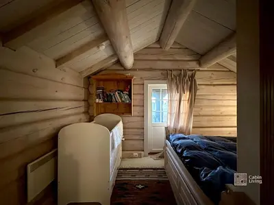a bedroom with a bed in a wooden room at Log cabin in Hafjell with ski in ski out, sauna and view in Hafjell