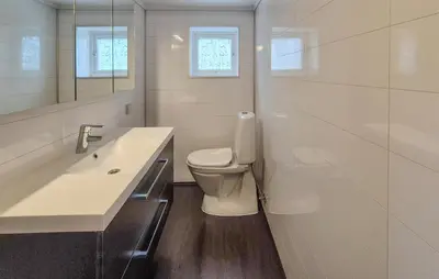 a white bathroom with a toilet and a sink at 3 Bedroom Stunning Home In Omastrand in Sanddal