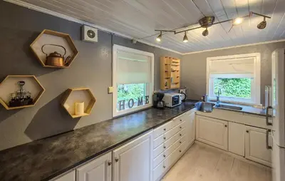 a kitchen with white cabinets and a counter top at 3 Bedroom Stunning Home In Omastrand in Sanddal