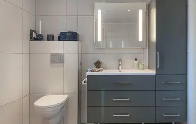 a bathroom with a toilet and a sink at 3 Bedroom Awesome Home In Nordfjordeid in Nordfjordeid