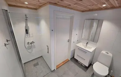 a bathroom with a shower and a toilet and a sink at 2 Bedroom Lovely Home In Bjordal in Hogvær