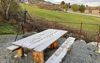 a wooden bench sitting on top of a field at Amazing Home In Oppdal in Oppdal