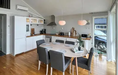 a kitchen and dining room with a table and chairs at 4 Bedroom Gorgeous Home In Bjugn in Moen