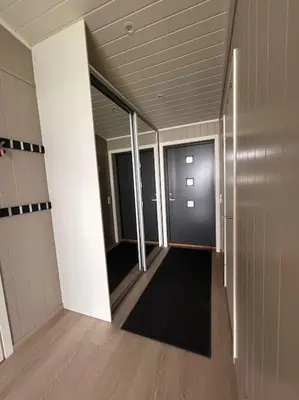 a hallway of an office building with a door and a hallway at Hytte v Farstadsanden Anders sandvigsvei 9 in Julshamn
